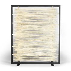 an art piece made out of bamboo sticks and black metal frame on a white background