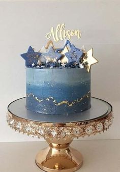 a blue and gold cake with stars on top is sitting on a plate that says, allison