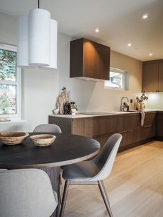 a modern kitchen and dining room with wood flooring