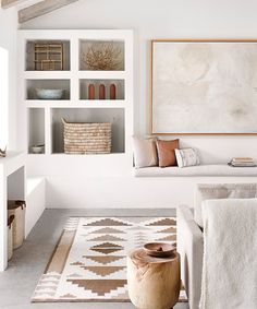 a living room filled with furniture and decor on top of a white carpeted floor