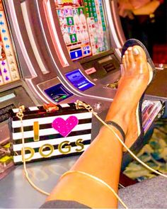 a woman's feet in front of a slot machine