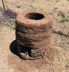 there is a large clay pot in the middle of the ground with dirt on it