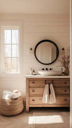 a bathroom with white walls and wood floors