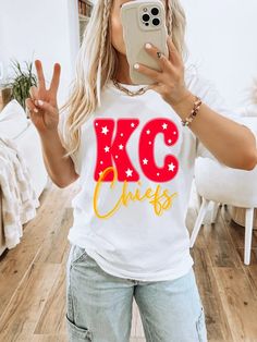 KC Chiefs in yellow and red font on a white tee. Unisex T-Shirt - true to size. Chiefs Shirt Ideas, Chiefs Shirt, Chiefs Shirts, Kc Chiefs, Girls Outerwear, Heel Slippers, Capri Blue