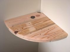 a wooden surfboard mounted to the wall with screws on it's side