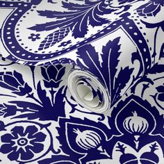 a blue and white wallpaper with an ornate design on it's side,