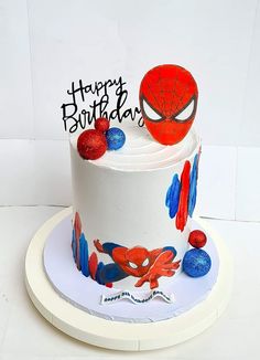 a spiderman birthday cake on a white plate