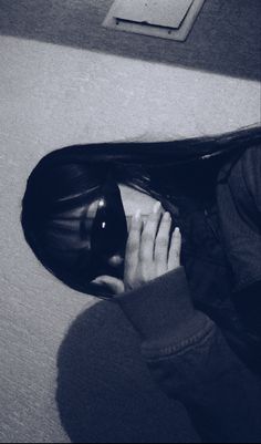 black and white photograph of a woman's hand on her hair