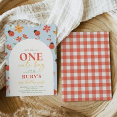 a red and white checkered table cloth next to a card