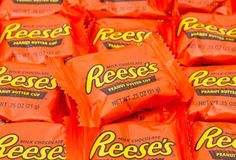 reese's peanut butter candy bars are stacked on top of each other in orange wrappers