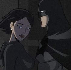 batman and batgirl in the dark knight animated film, which is being watched by two people