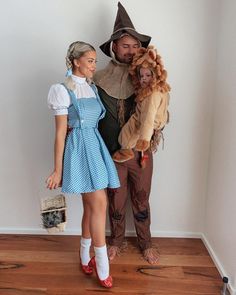 a man and woman dressed up as wizard and scarecrows