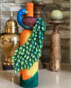 a peacock figurine sitting on top of an orange pillar