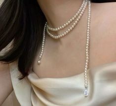 Discover the timeless elegance of our 50-inch Swarovski pearl necklace, a masterpiece of classic beauty and versatility. Crafted with premium 6mm Swarovski pearls, this exquisite strand offers a luxurious touch with endless styling possibilities. Wear it long for a graceful, flowing look, double it for a sophisticated layered effect, or knot it for a modern twist. Perfect as a thoughtful anniversary gift or a versatile addition to any jewelry collection, this necklace invites you to experiment with different styles for various occasions. Celebrate lasting elegance with this stunningly versatile piece, designed to be cherished for years to come. Elegant Pearl White Backdrop Necklace, Elegant Pearl Chain Backdrop Necklace For Evening, Elegant Pearl Pendant Backdrop Necklace For Party, Elegant Evening Backdrop Necklace With Pearl Chain, Elegant Pearl White Backdrop Necklace For Party, Elegant Pearl Backdrop Necklace For Party, Elegant Long Single Strand Pearl Necklace, Elegant White Pearl Chain Backdrop Necklace, Elegant Pearl Backdrop Necklace With Pearl Drop