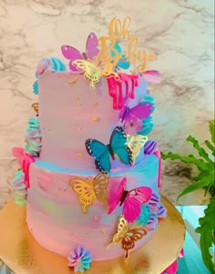 there is a multi layer cake with butterflies on it