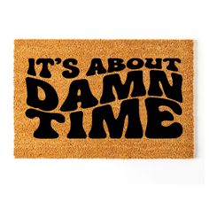 a door mat that says it's about damn time with the words on it