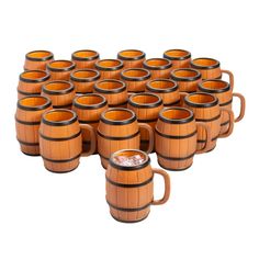 a large group of wooden mugs sitting next to each other