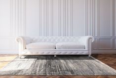 a white couch sitting on top of a wooden floor