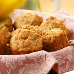 some muffins are in a basket on a table