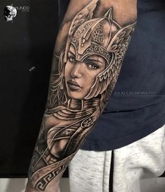 a woman with a helmet on her head is shown in this black and grey tattoo