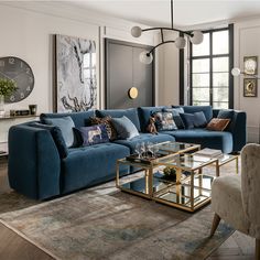 a living room filled with furniture and a large clock mounted to the wall above it