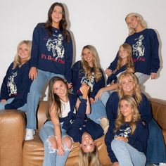 a group of young women sitting on top of a brown leather couch next to each other