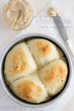 a pan filled with rolls next to a bowl of peanut butter