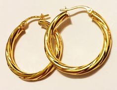 Fancy style, swirly hoop earrings:metal        : solid 14k yellow goldcast           : hollowweight      = 2.3 grdiameter  = 1.25"inch (30mm)thick          = 3 mmclosure      : snap downmade         : in Italy Modern Twist Small Hoop Jewelry Gift, Modern Twist Small Hoop Earrings For Gift, Modern Twist Small Hoop Earrings As Gift, Modern Twist Hoop Earrings As Gift, Modern Twist Yellow Gold Hoop Earrings As Gift, Elegant Cadmium-free Hoop Earrings As Gift, Elegant Hypoallergenic Hoop Earrings As Gift, Spiral Yellow Gold Hoop Earrings For Gift, Spiral Yellow Gold Hoop Earrings As Gift