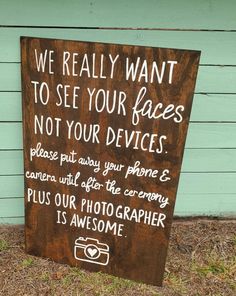 a wooden sign that says, we really want to see your faces not your devices