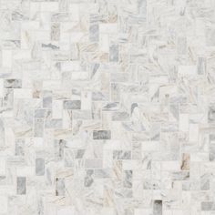 a white marble tile wall with grey and beige squares