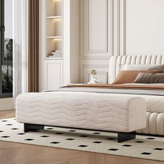 a white bed sitting on top of a wooden floor