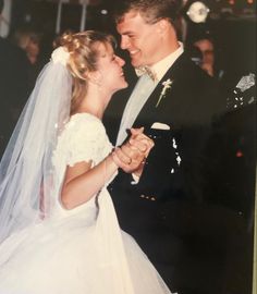 a bride and groom dance together at their wedding