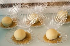 four glass dishes with desserts in them on a table