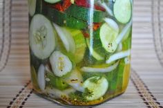 a jar filled with sliced cucumbers and other vegetables