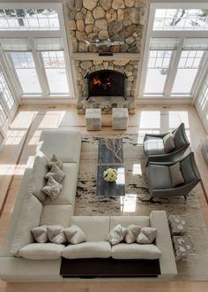 an aerial view of a living room with couches, chairs and a fire place