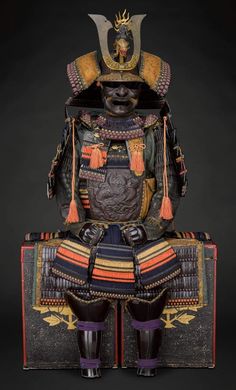 an elaborately decorated statue sitting on top of a wooden box