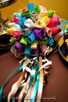 the bridal bouquet is made up of colorful ribbons