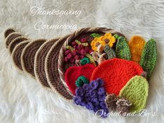 there are many crocheted hats on the white furnishing that is laying on top of each other