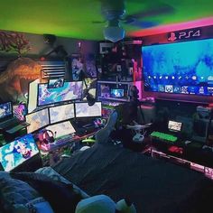 a room filled with lots of computer monitors and gaming equipment on top of each other