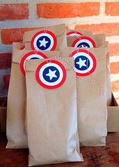 some brown paper bags with captain america tags on them