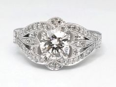 a diamond ring with an intricate design on the side