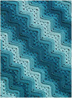 a blue crocheted afghan is shown