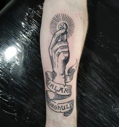 a black and white tattoo on the arm of a person with a sun above it