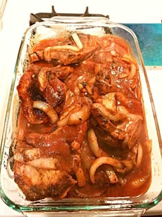 a glass dish filled with meat covered in sauce