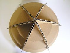 four pieces of cardboard sitting on top of a white plate with black lines in the middle