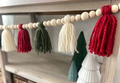 several tassels are hanging from a shelf