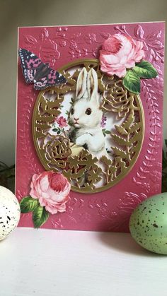 a card with an image of a rabbit and flowers on it