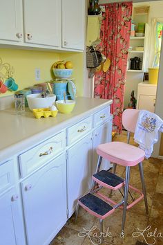 a pink chair sitting on top of a kitchen counter