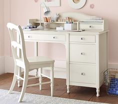 a white desk with a chair and a mirror