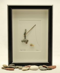 a clock made out of rocks and pebbles